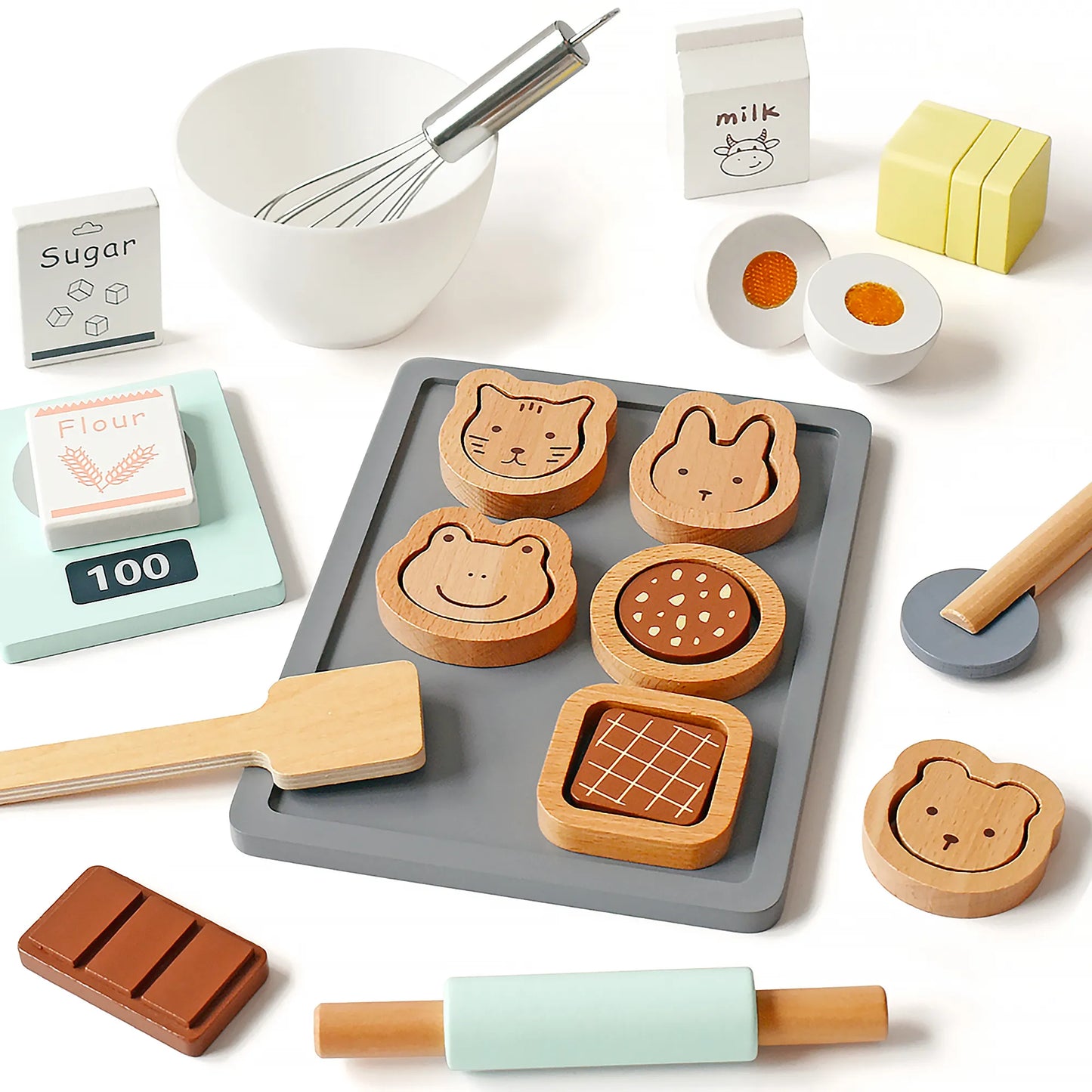 Flat lay view of a kids wooden baking toy set. Features pretend play food like cute animal cookies, a toy rolling pin, cuttable egg, and whisk.