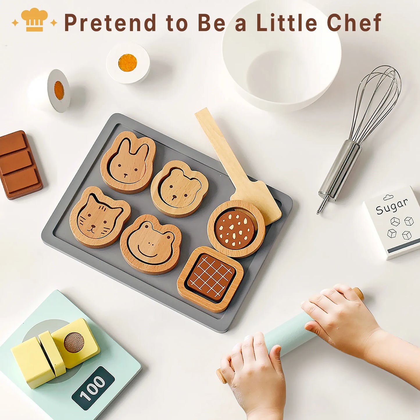 Toddler hands using a toy rolling pin in a pretend play kitchen. This wooden baking set lets kids act as little chefs making play food cookies.