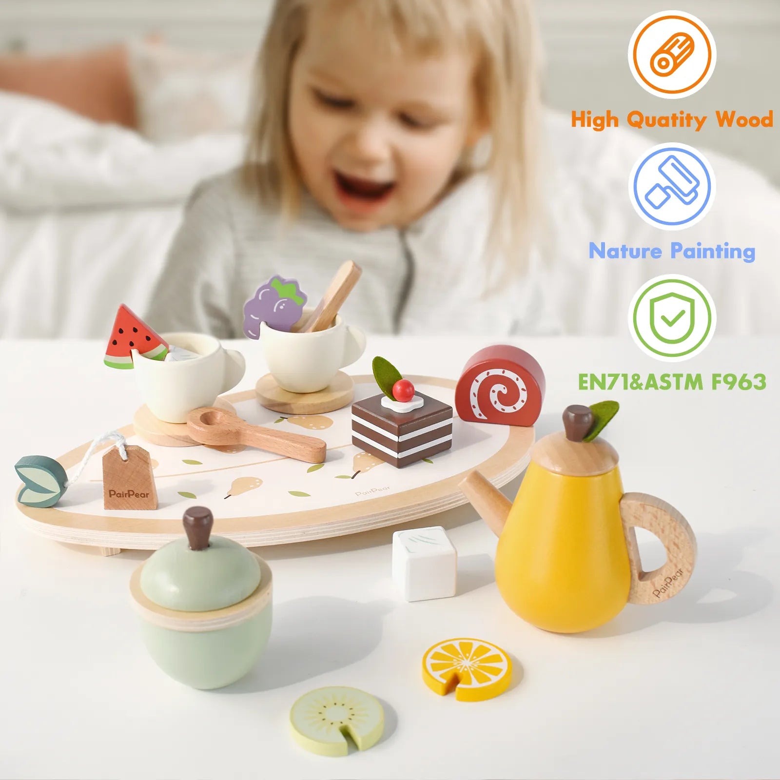 Happy toddler playing with a safe, natural wooden tea set. This pretend play food toy is made of high-quality wood and uses non-toxic paint