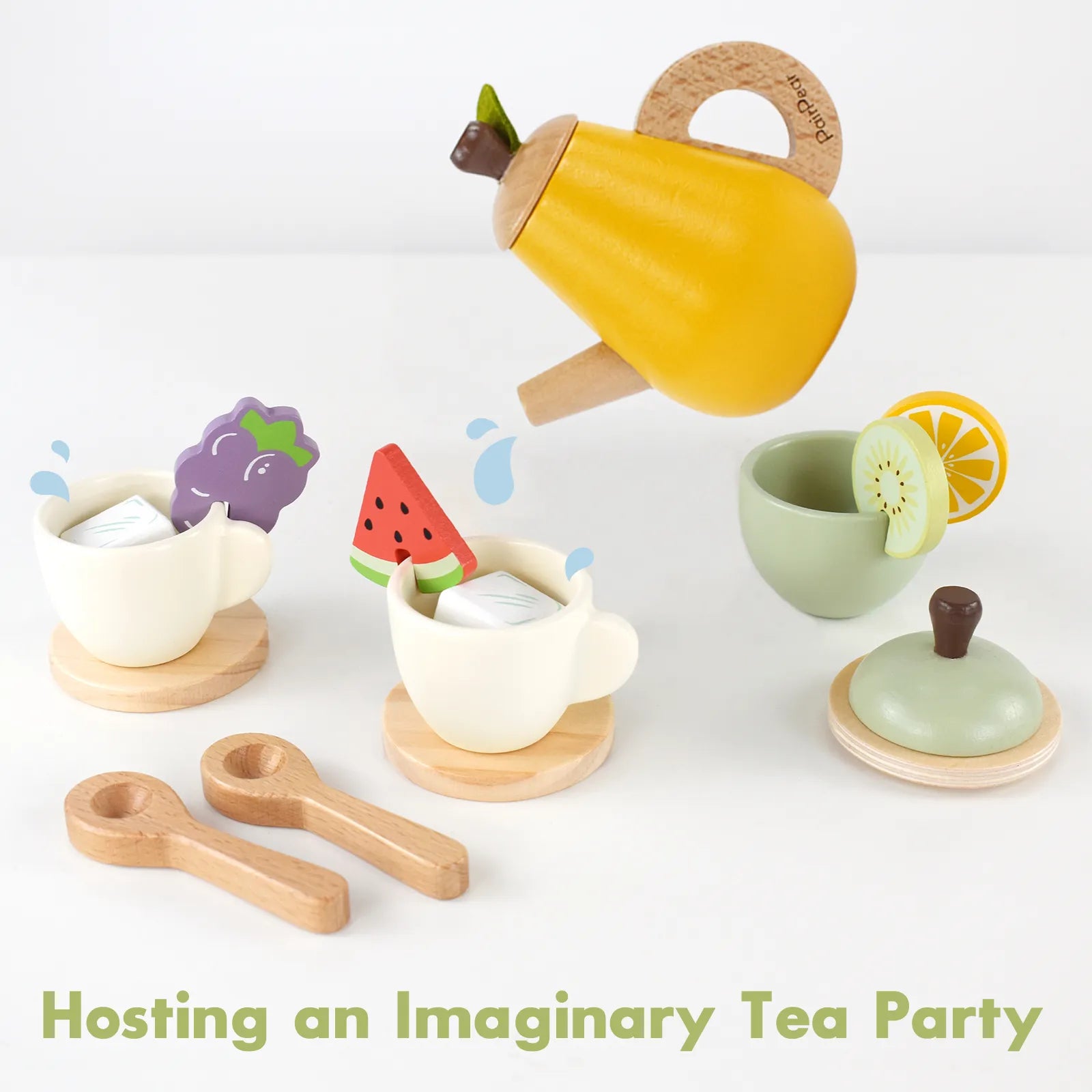 Interactive kids wooden tea set. The yellow pretend teapot is pouring into teacups filled with sugar cubes and garnished with fruit play food